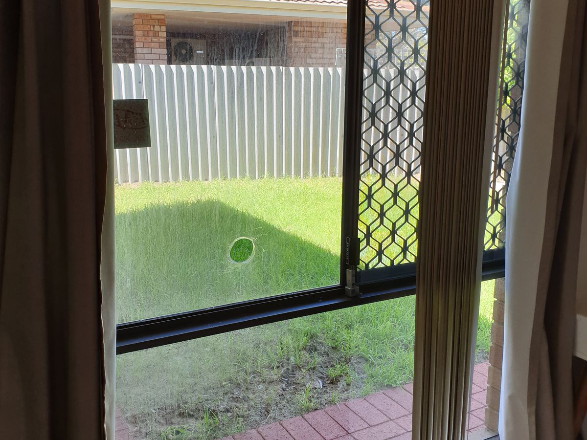 Window pane with impact hole — Bayswater, before