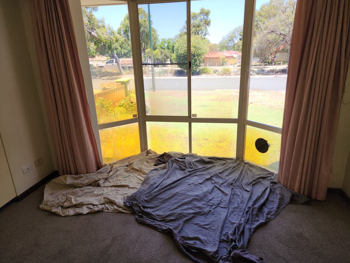 Bay window pane with hole awaiting replacement — Como, before