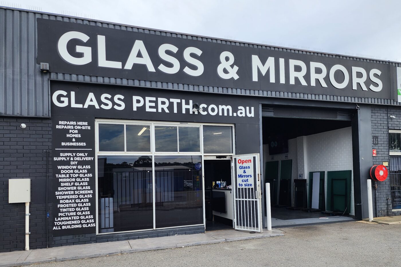 The Glass Perth shopfront in Greenwood — Glass & Mirrors signage above the open workshop door, with cut glass panels inside
