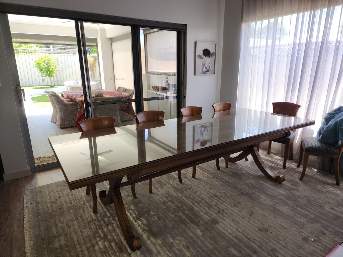 Clear glass top cut to size on a timber dining table