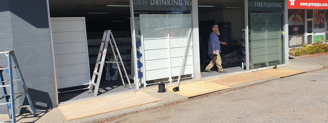Shopfront with glass removed during reglaze — Total Eden, before