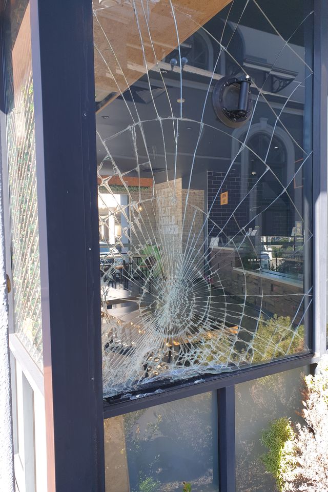 Smashed toughened shopfront pane — Zambrero, before